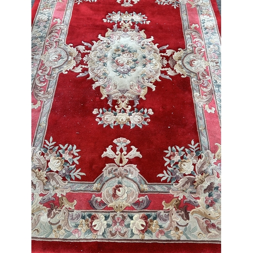 88A - A red floral pattern rug - approx. 280cm x 183cm