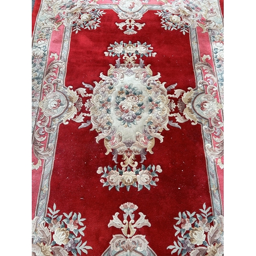 88A - A red floral pattern rug - approx. 280cm x 183cm