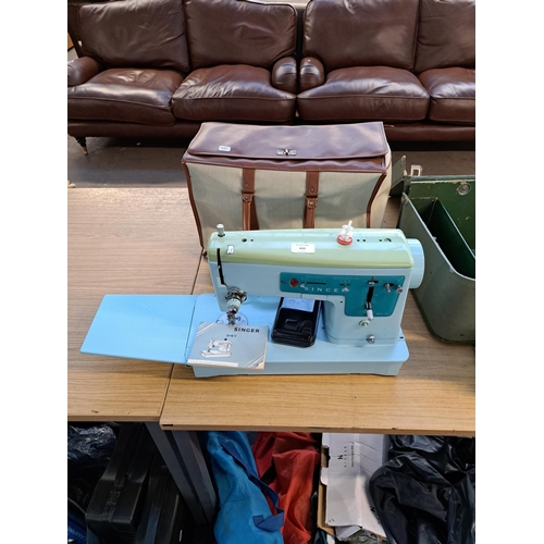 832 - A cased Singer 347 electric sewing machine with foot pedal and instruction manual