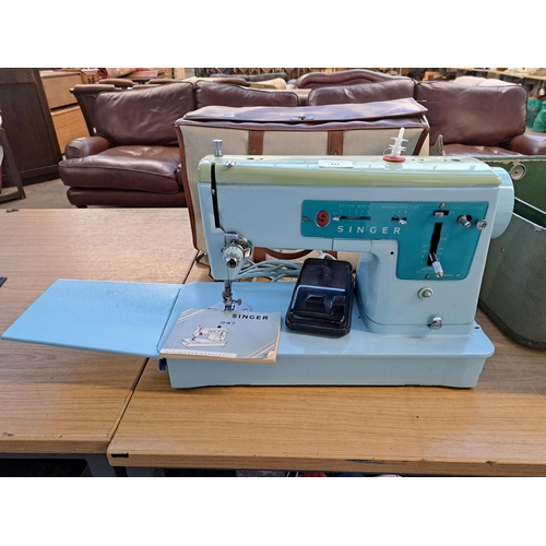 832 - A cased Singer 347 electric sewing machine with foot pedal and instruction manual