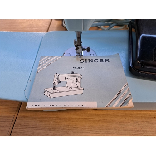 832 - A cased Singer 347 electric sewing machine with foot pedal and instruction manual