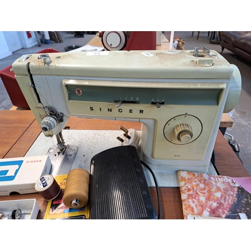 838 - A Singer 507 electric sewing machine with foot pedal, stand, accessories and instruction manual