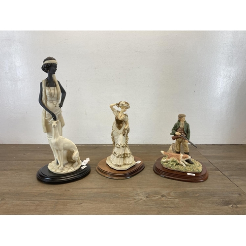 389 - Three resin figurines to include The Leonardo Collection The Promenade, The Leonardo Collection Game... 