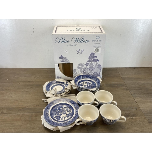 393 - A boxed Churchill blue willow twenty piece dinner service