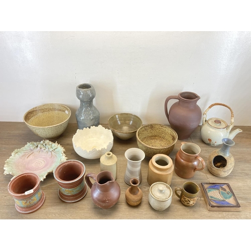 406 - A collection of studio pottery to include Lisa Larson style wall tile etc.