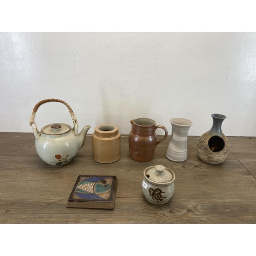 406 - A collection of studio pottery to include Lisa Larson style wall tile etc.