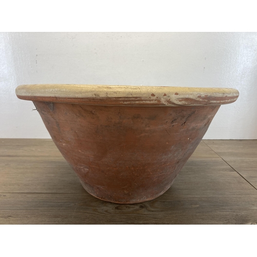 416 - A 19th century salt glazed terracotta dairy bowl - approx. 22cm high x 44cm diameter