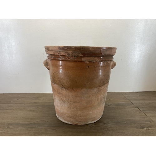 420 - A large 19th century glazed terracotta twin handled storage jar - approx. 37cm high x 37.5cm diamete... 