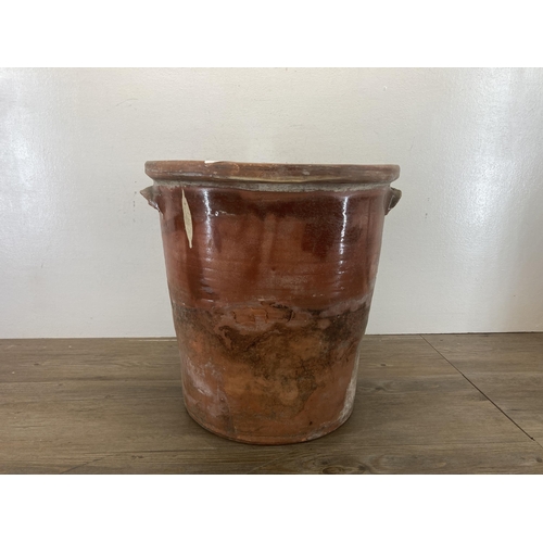 421 - A large 19th century glazed terracotta twin handled storage jar - approx. 38cm high x 37cm diameter