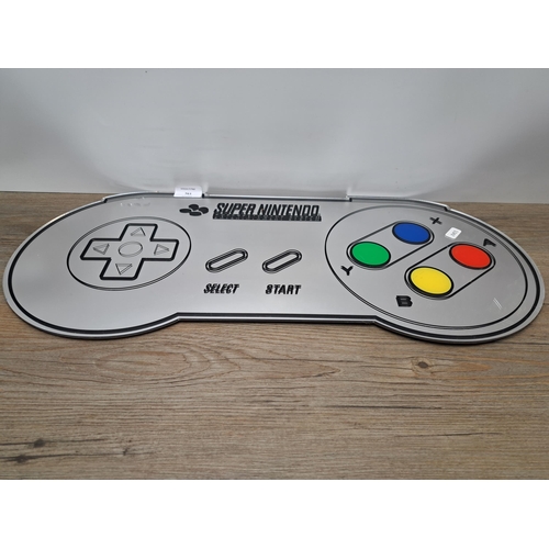 761 - A Paladone Super Nintendo Entertainment System wall mirror - approx. 60cm wide x 27cm high