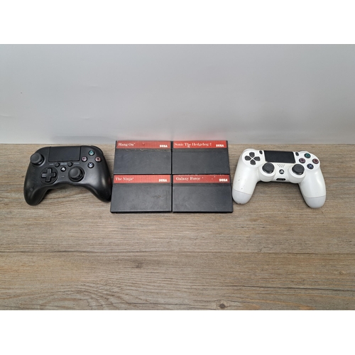 767 - A collection of console gaming items to include three Sony PlayStation 3 consoles, PlayStation 4 whi... 