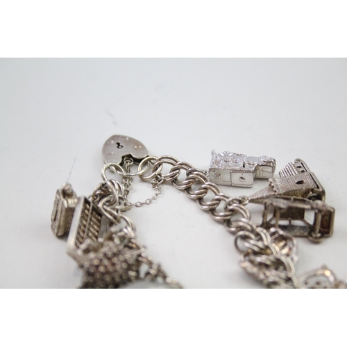 2111 - Two silver charm bracelets with assorted charms - approx. gross weight 85g