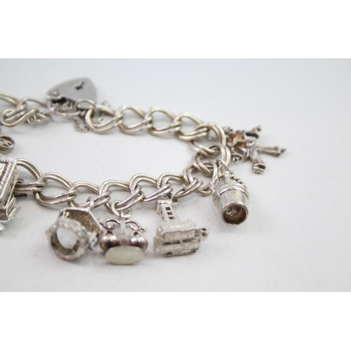 2111 - Two silver charm bracelets with assorted charms - approx. gross weight 85g