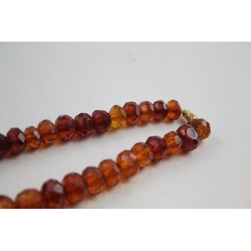 2115 - A single strand faceted amber beaded necklace - approx. gross weight 45g