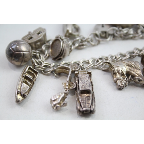 2147 - A vintage silver charm bracelet with assorted charms - approx. gross weight 57g