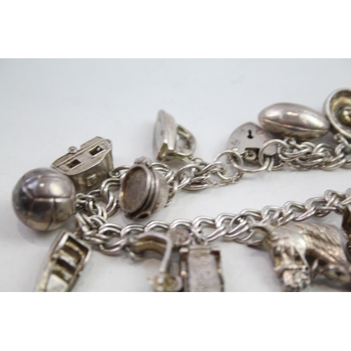 2147 - A vintage silver charm bracelet with assorted charms - approx. gross weight 57g