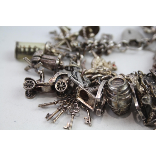 2152 - A hallmarked .925 silver charm bracelet with assorted charms - approx. gross weight 150g