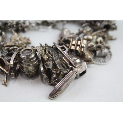 2152 - A hallmarked .925 silver charm bracelet with assorted charms - approx. gross weight 150g