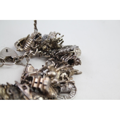 2152 - A hallmarked .925 silver charm bracelet with assorted charms - approx. gross weight 150g