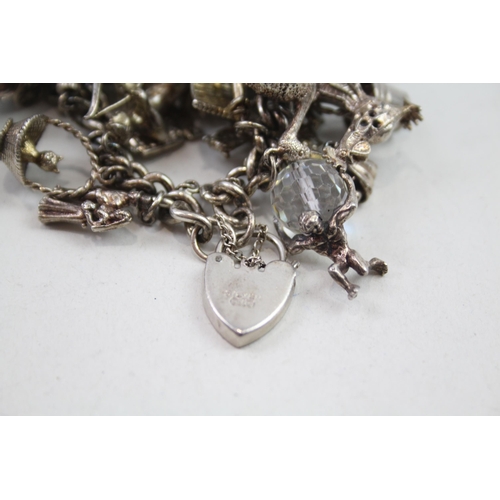 2152 - A hallmarked .925 silver charm bracelet with assorted charms - approx. gross weight 150g