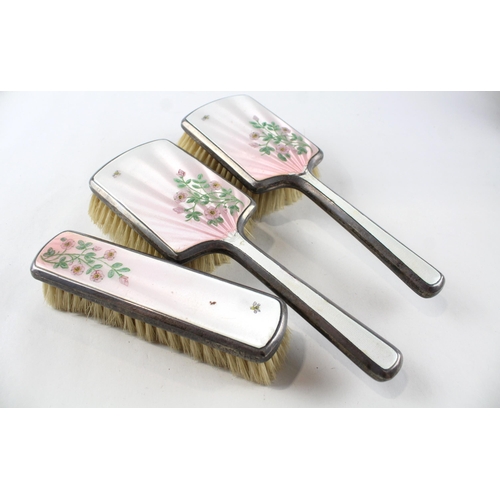 2196 - A hallmarked London sterling silver and guilloche enamel  three piece dressing table set, dated 1947... 