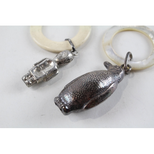 2208 - Two hallmarked .925 sterling silver baby rattles, one penguin hallmarked Birmingham 1939 and one gua... 