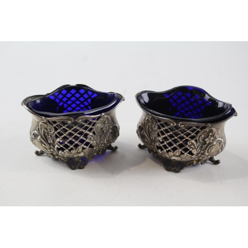 2212 - Two William Aitken hallmarked Birmingham sterling silver salt cellars with blue glass inserts - appr... 