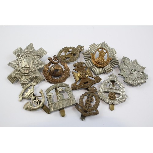 2305 - A collection of vintage military cap badges