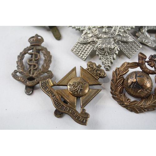 2305 - A collection of vintage military cap badges