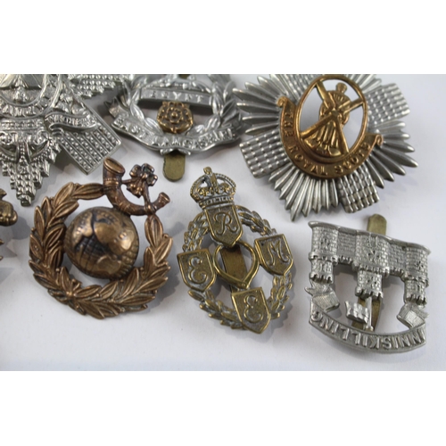 2305 - A collection of vintage military cap badges