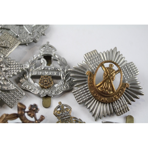 2305 - A collection of vintage military cap badges