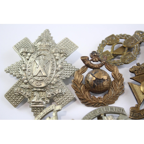 2305 - A collection of vintage military cap badges