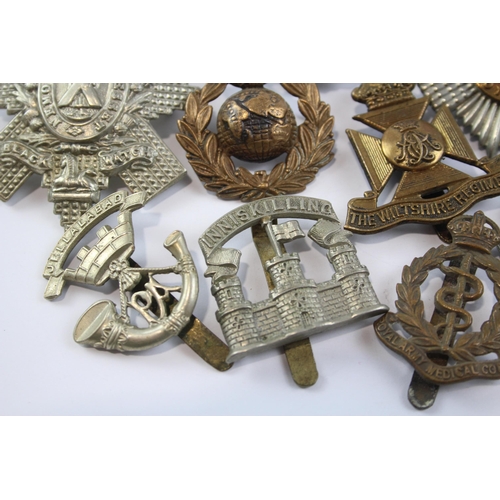 2305 - A collection of vintage military cap badges