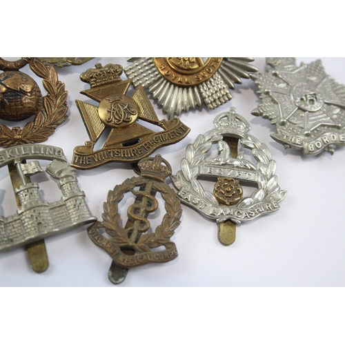 2305 - A collection of vintage military cap badges