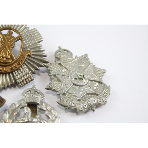 2305 - A collection of vintage military cap badges