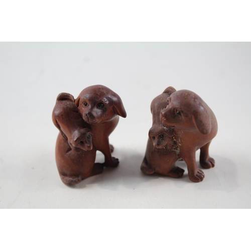 2337 - Two Oriental carved wooden netsuke figurines signed to base