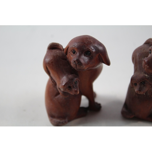 2337 - Two Oriental carved wooden netsuke figurines signed to base