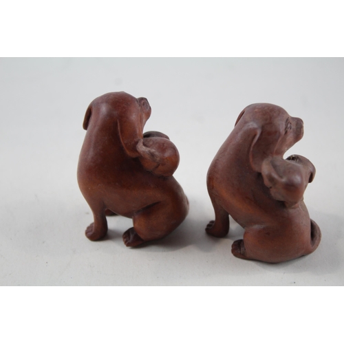 2337 - Two Oriental carved wooden netsuke figurines signed to base