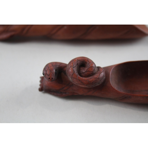 2338 - Two Oriental carved wooden zodiac snake tea/coffee scoops signed to base