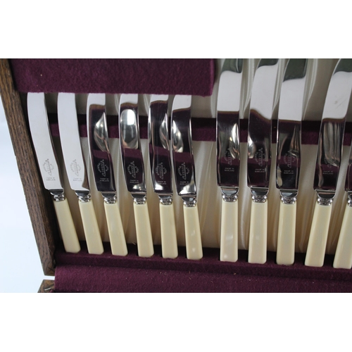 457 - A Viners 102 piece stainless steel and ivorine canteen of cutlery