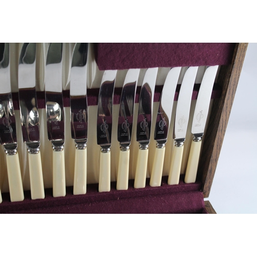 457 - A Viners 102 piece stainless steel and ivorine canteen of cutlery