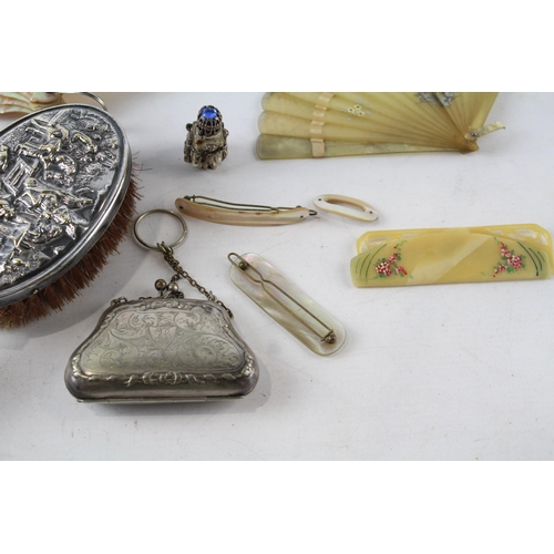 547 - A collection of vintage ladies vanity items to include mother of pearl fan, hairbrush, purse, haircl... 