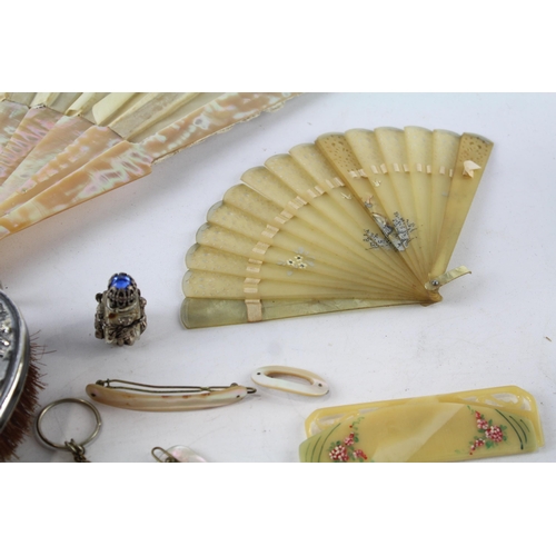 547 - A collection of vintage ladies vanity items to include mother of pearl fan, hairbrush, purse, haircl... 