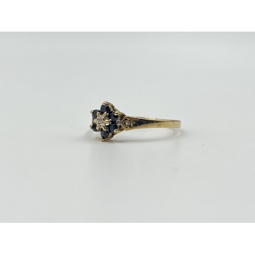 2016 - A hallmarked Birmingham 9ct gold sapphire and diamond floral cluster ring with diamond set shoulders... 