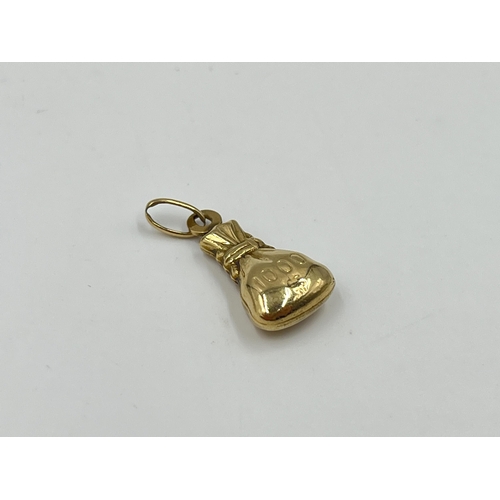 2023 - A 9ct gold money bag pendant - approx. gross weight 0.95g