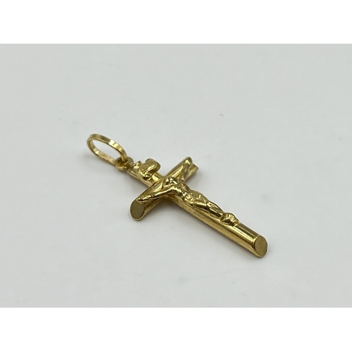 2038 - A 9ct gold crucifix pendant - approx. gross weight 0.84g