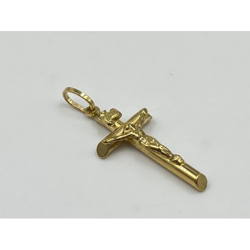 2038 - A 9ct gold crucifix pendant - approx. gross weight 0.84g