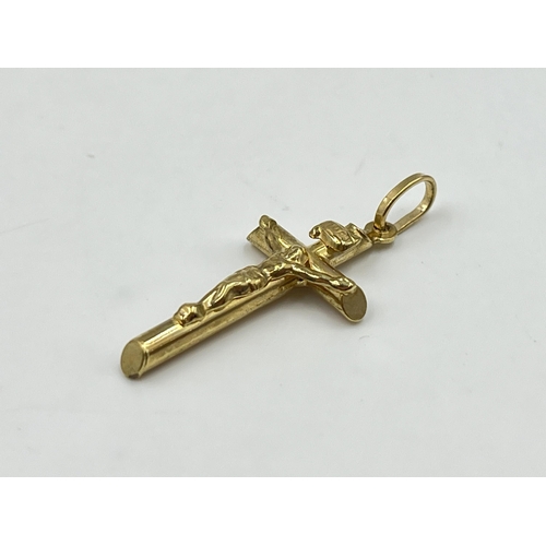 2038 - A 9ct gold crucifix pendant - approx. gross weight 0.84g