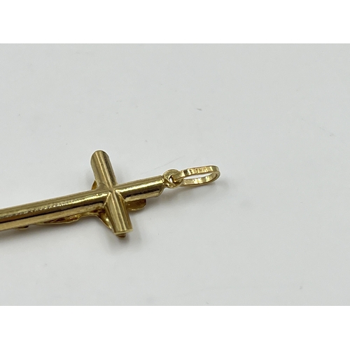 2038 - A 9ct gold crucifix pendant - approx. gross weight 0.84g