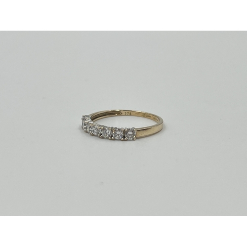 2040 - A 9ct gold CZ seven stone ring, size Q½ - approx. gross weight 1.7g